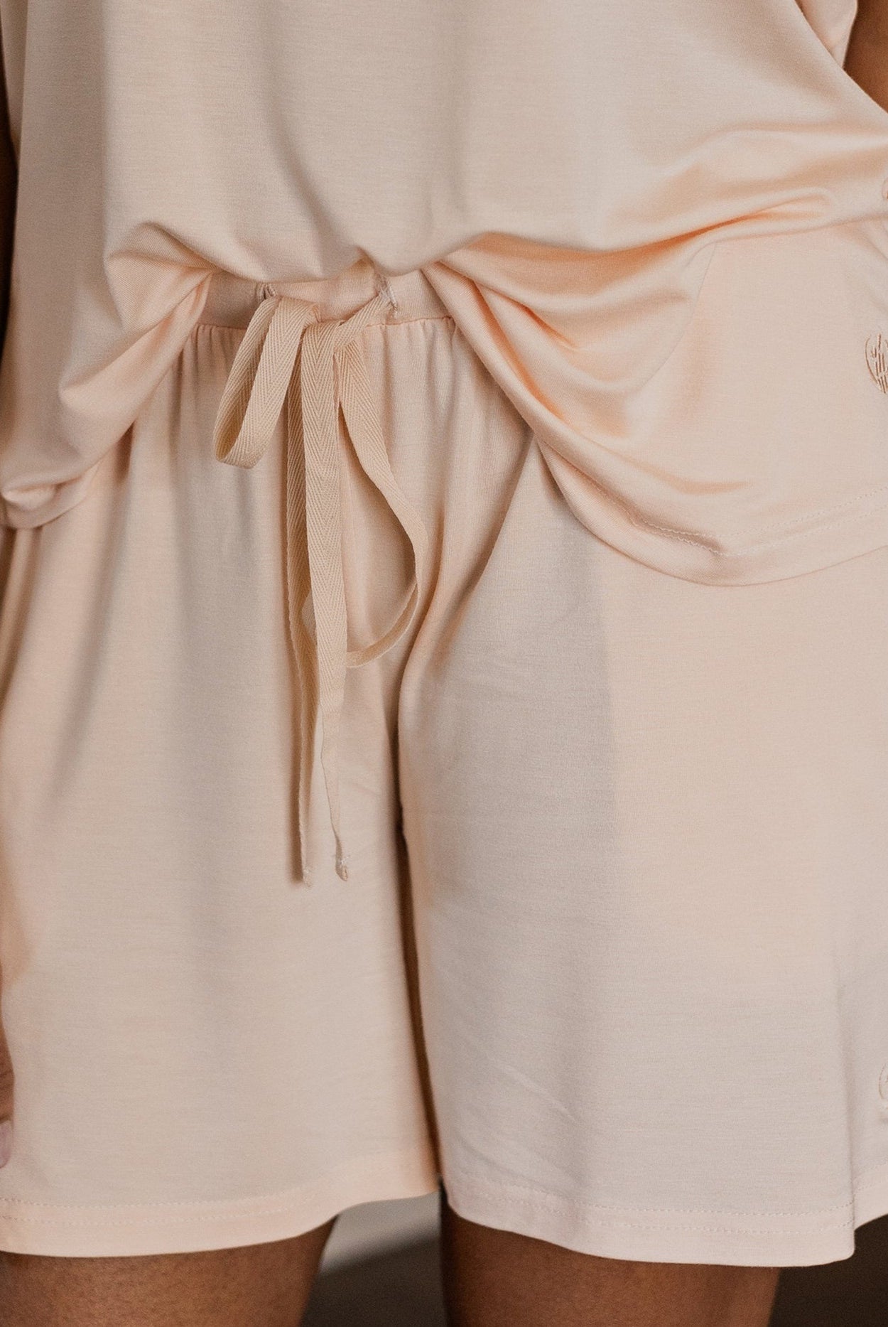 Lightweight bamboo pajama set with a relaxed short-sleeve top and breathable shorts, designed to keep you cool, fresh, and comfortable all night long.