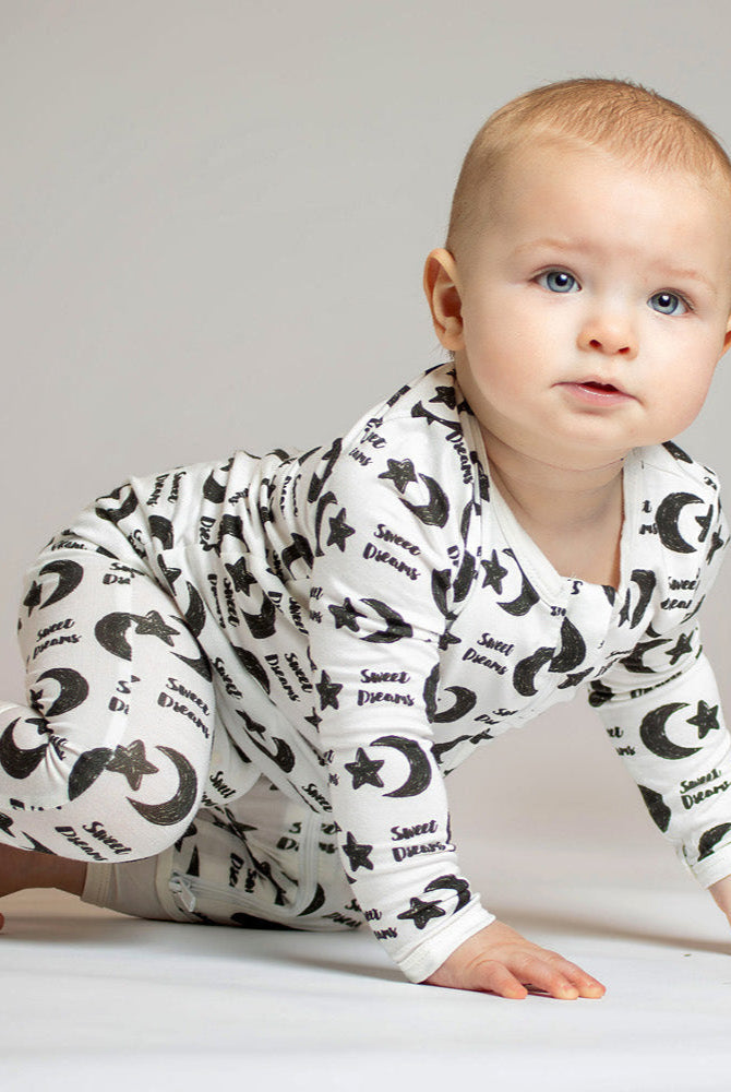Sweet Dreams bamboo zip romper with a celestial pattern of stars, moons, and soft "Sweet Dreams" lettering for a cozy night’s sleep.