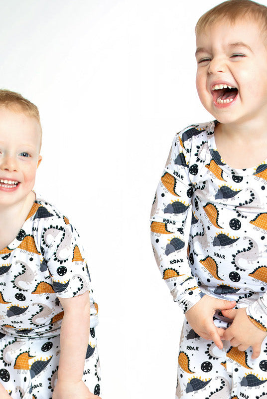Earthly Threads Roaring Dinosaur Pajama Set, featuring playful dinosaur prints and “ROAR” lettering on a soft bamboo long-sleeve top and matching pants.