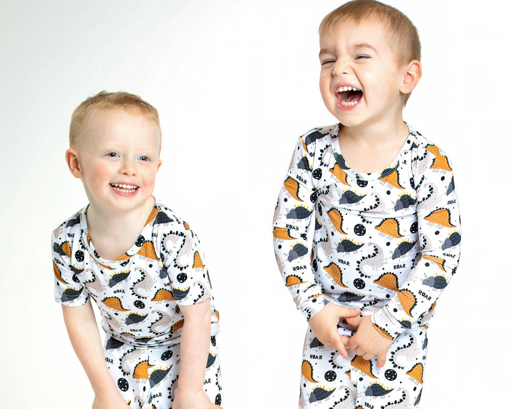 Earthly Threads Roaring Dinosaur Pajama Set, featuring playful dinosaur prints and “ROAR” lettering on a soft bamboo long-sleeve top and matching pants.