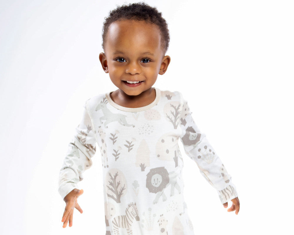 Earthly Threads safari-themed long sleeve bamboo romper with zebras, lions, and giraffes for little explorers.
