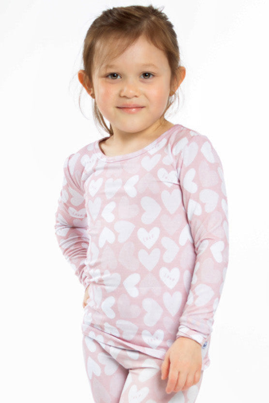 Earthly Threads Full of Heart bamboo pajama set with pink and white hearts and soft "Love" lettering.