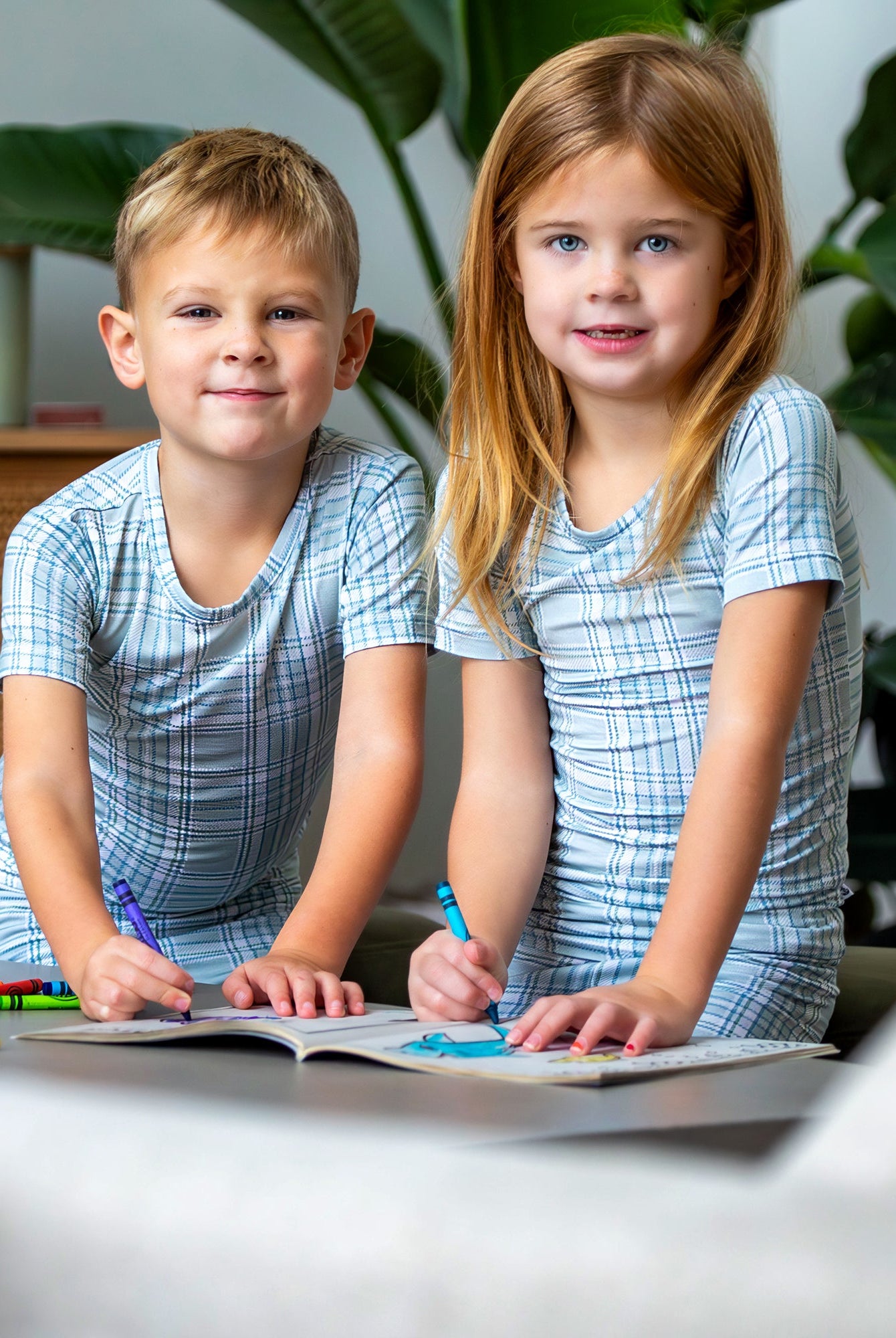 Earthly Threads buffalo plaid bamboo kids pajamas in neutral blue and white, available in short or long sleeves.