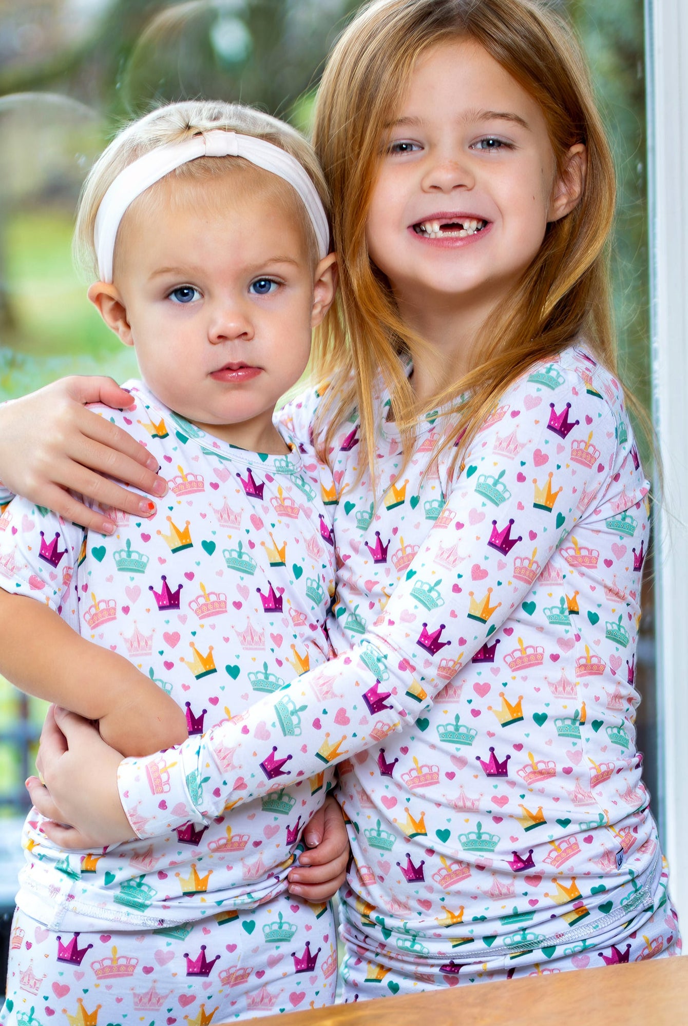 Pink and gold hearts and crowns kids’ pajama set made from Earthly Threads' antibacterial bamboo fabric.