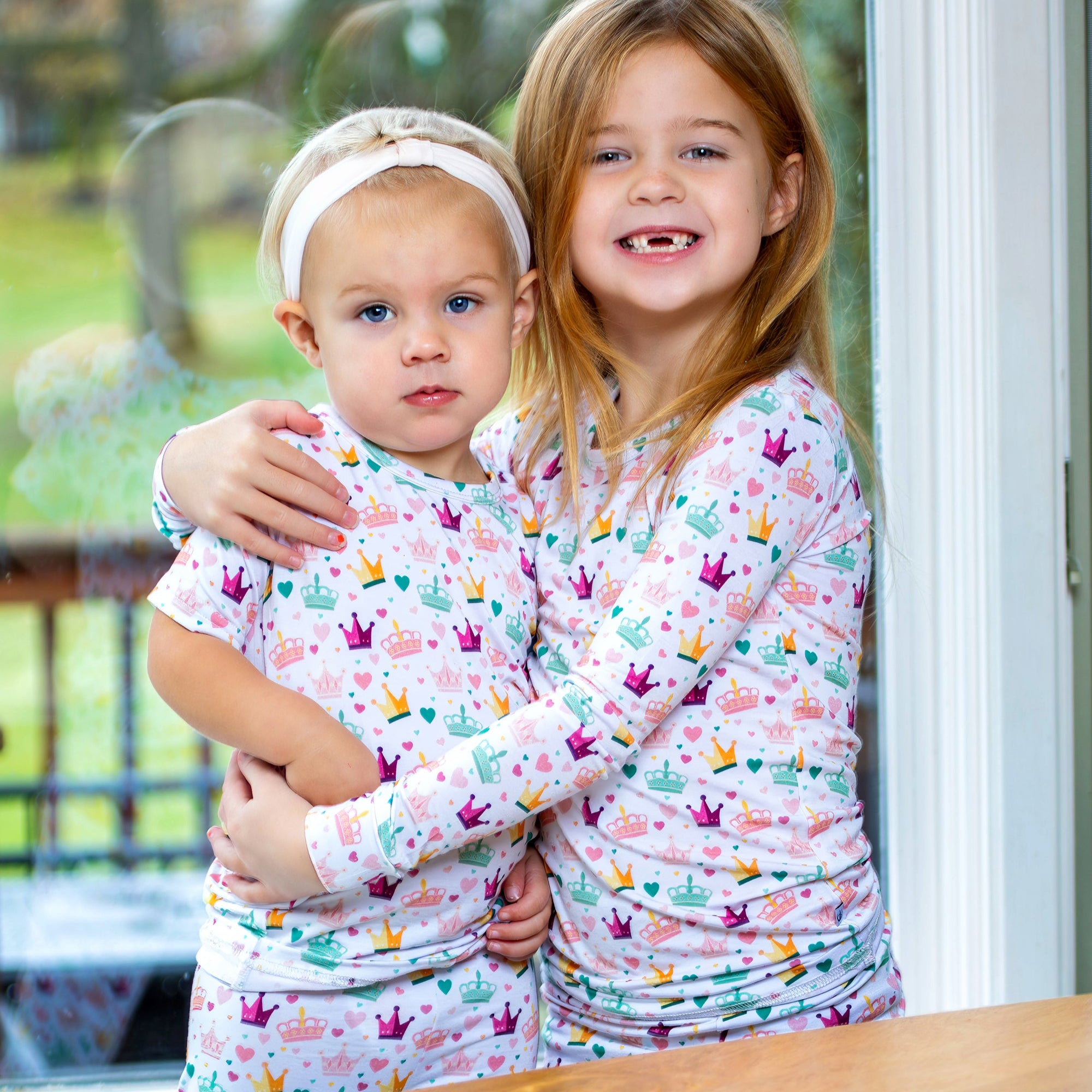 Pink and gold hearts and crowns kids’ pajama set made from Earthly Threads' antibacterial bamboo fabric.