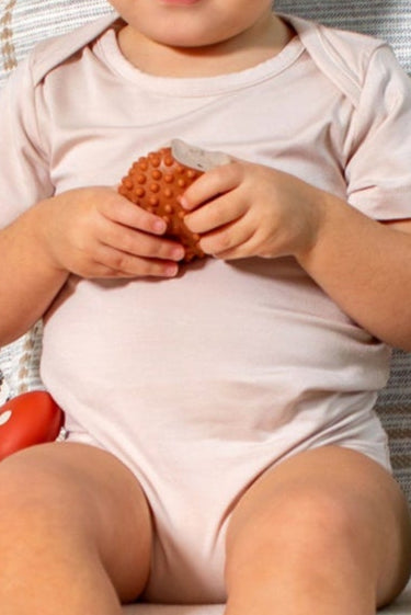 Essential bamboo short sleeve bodysuit in petal blush, designed for softness and stretch by Earthly Threads.