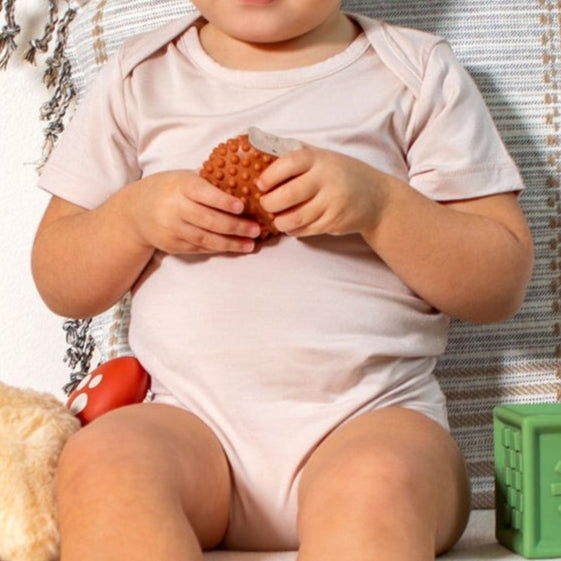 Essential bamboo short sleeve bodysuit in petal blush, designed for softness and stretch by Earthly Threads.