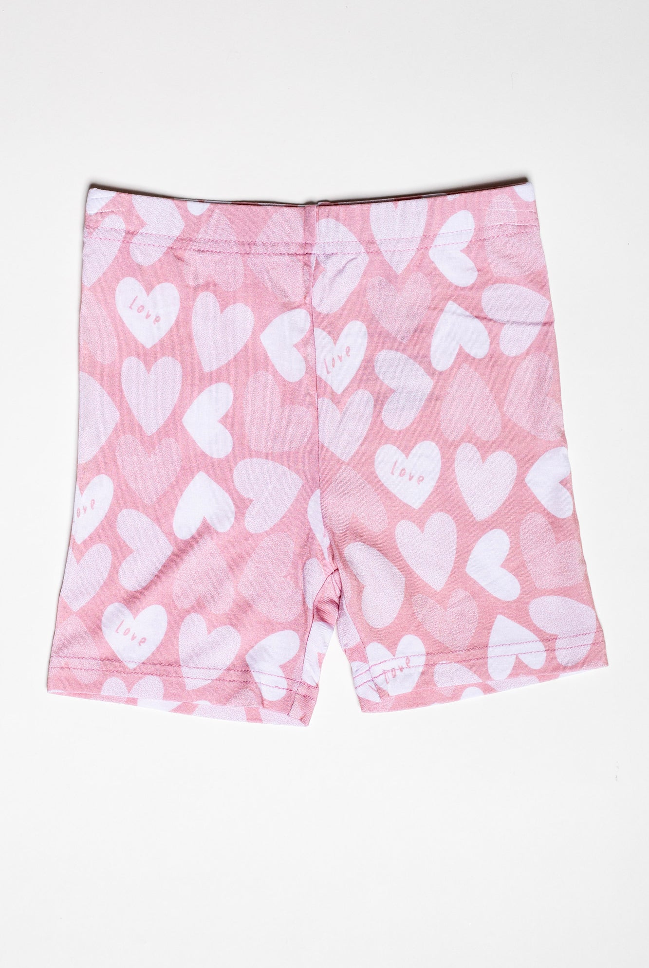Organic bamboo short sleeve pajama set with matching shorts, featuring an adorable, pink heart print.