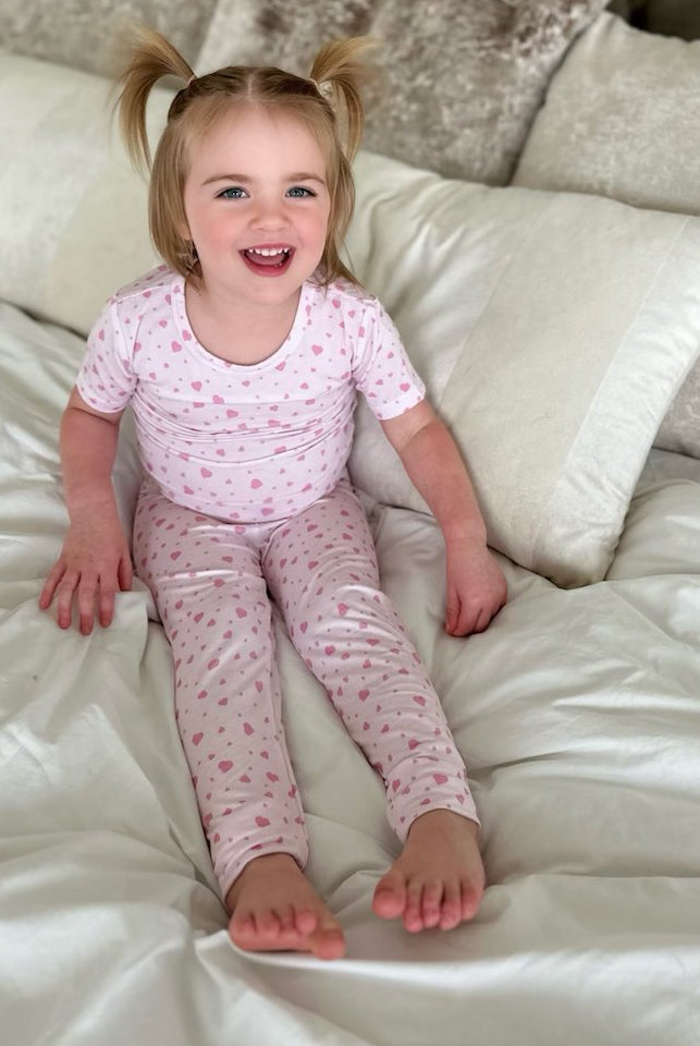 Earthly Threads bamboo pajama set for kids, featuring an adorable pink heart pattern on a soft, breathable fabric.