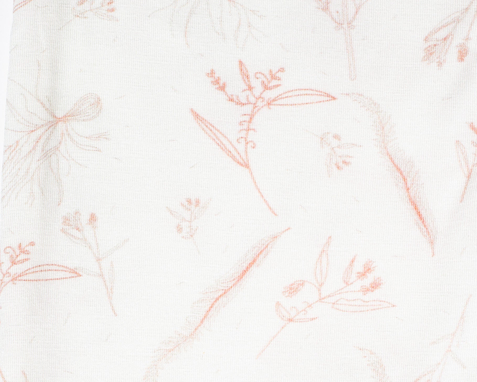 Elegant and practical bamboo baby romper with a delicate rose-inspired floral pattern and a smooth zipper closure.