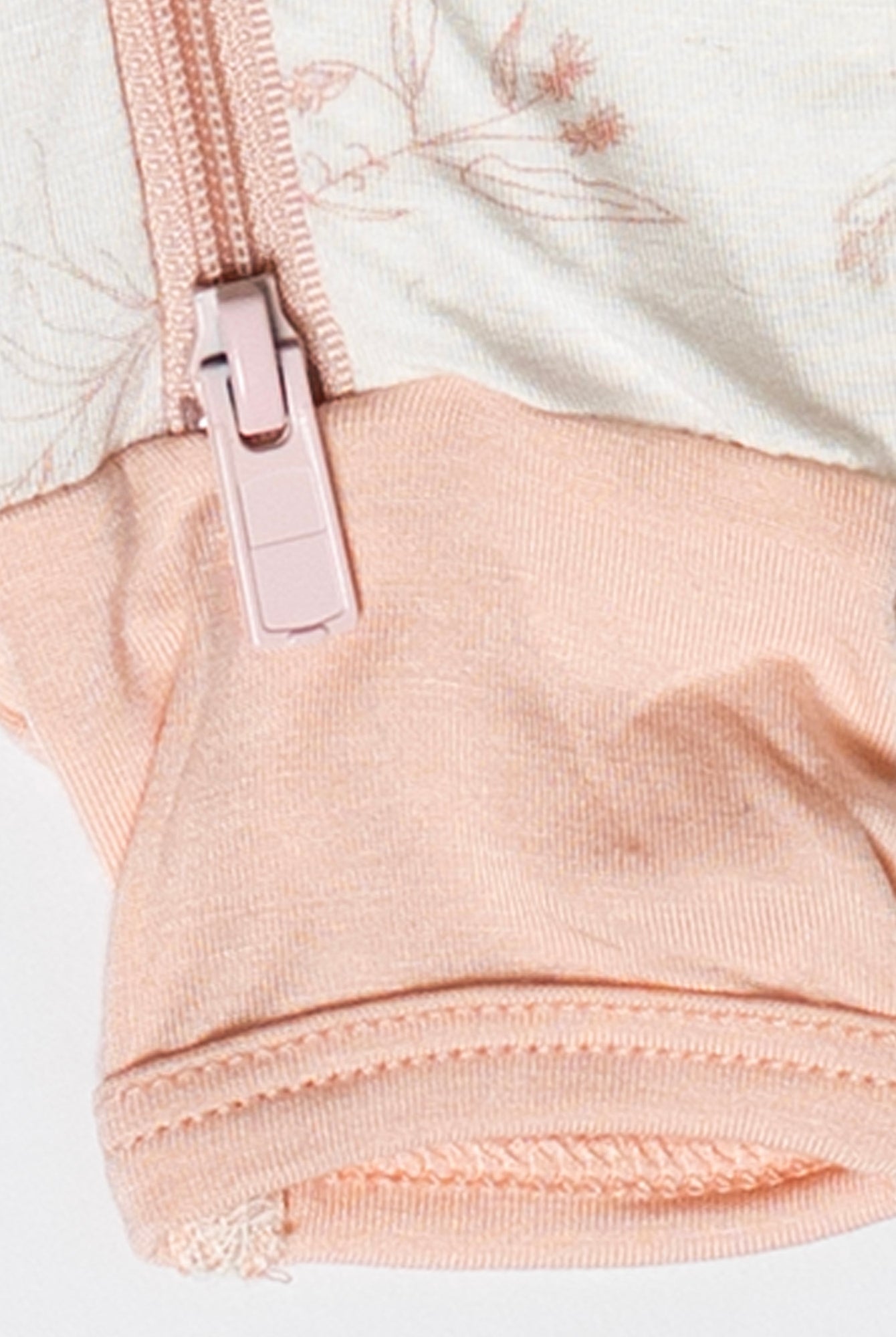 Sustainable and stylish baby sleeper with a zip-up front for easy changes and a beautiful floral pattern.