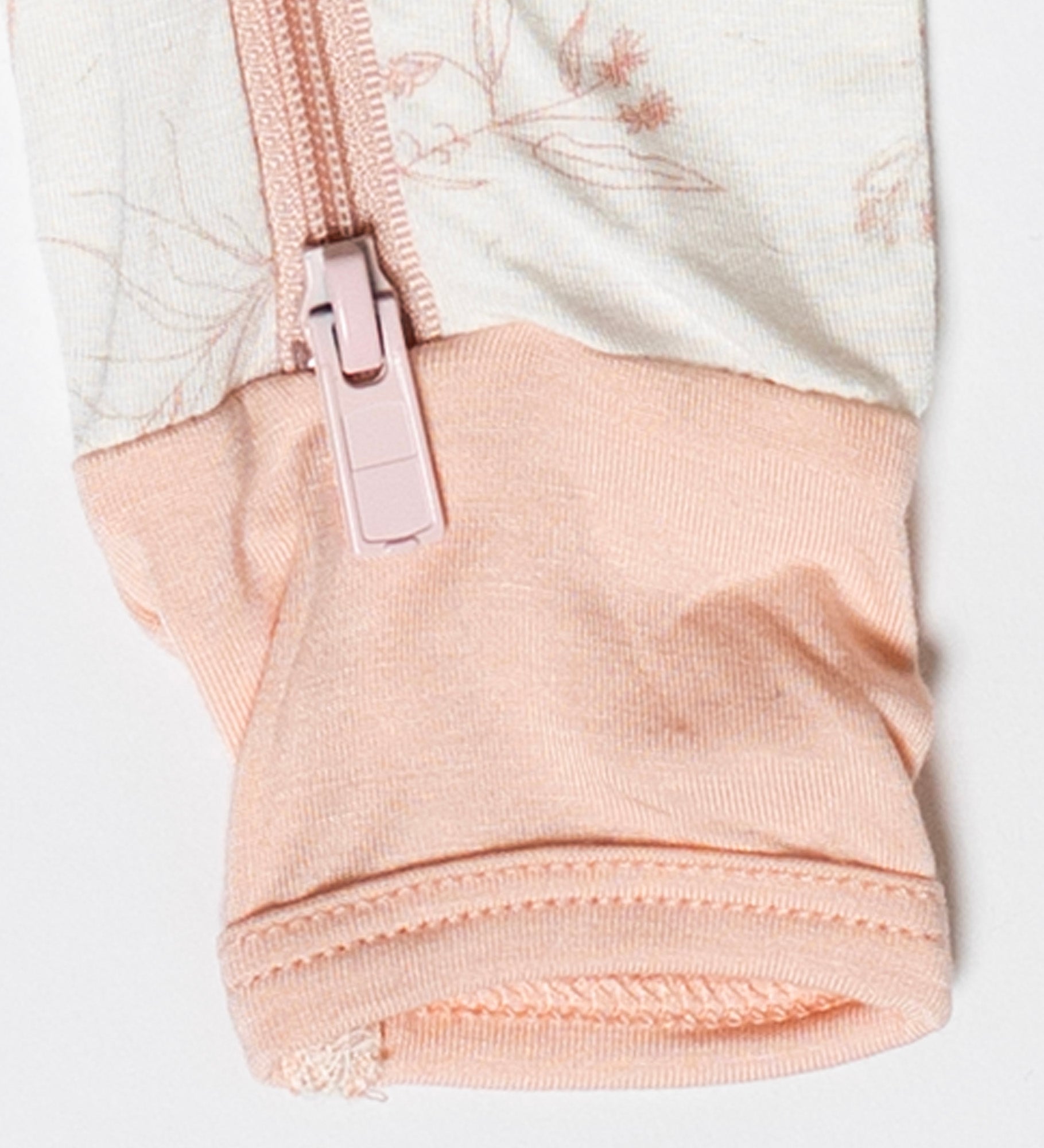 Sustainable and stylish baby sleeper with a zip-up front for easy changes and a beautiful floral pattern.