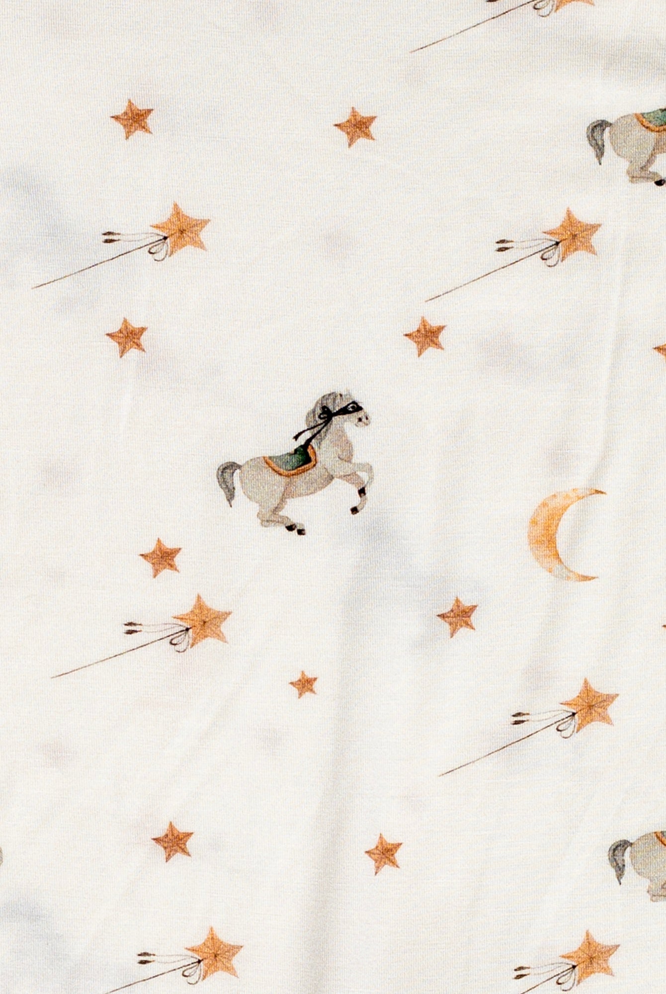 Ultra-soft bamboo long sleeve romper featuring a playful pony pattern with golden stars and moons.