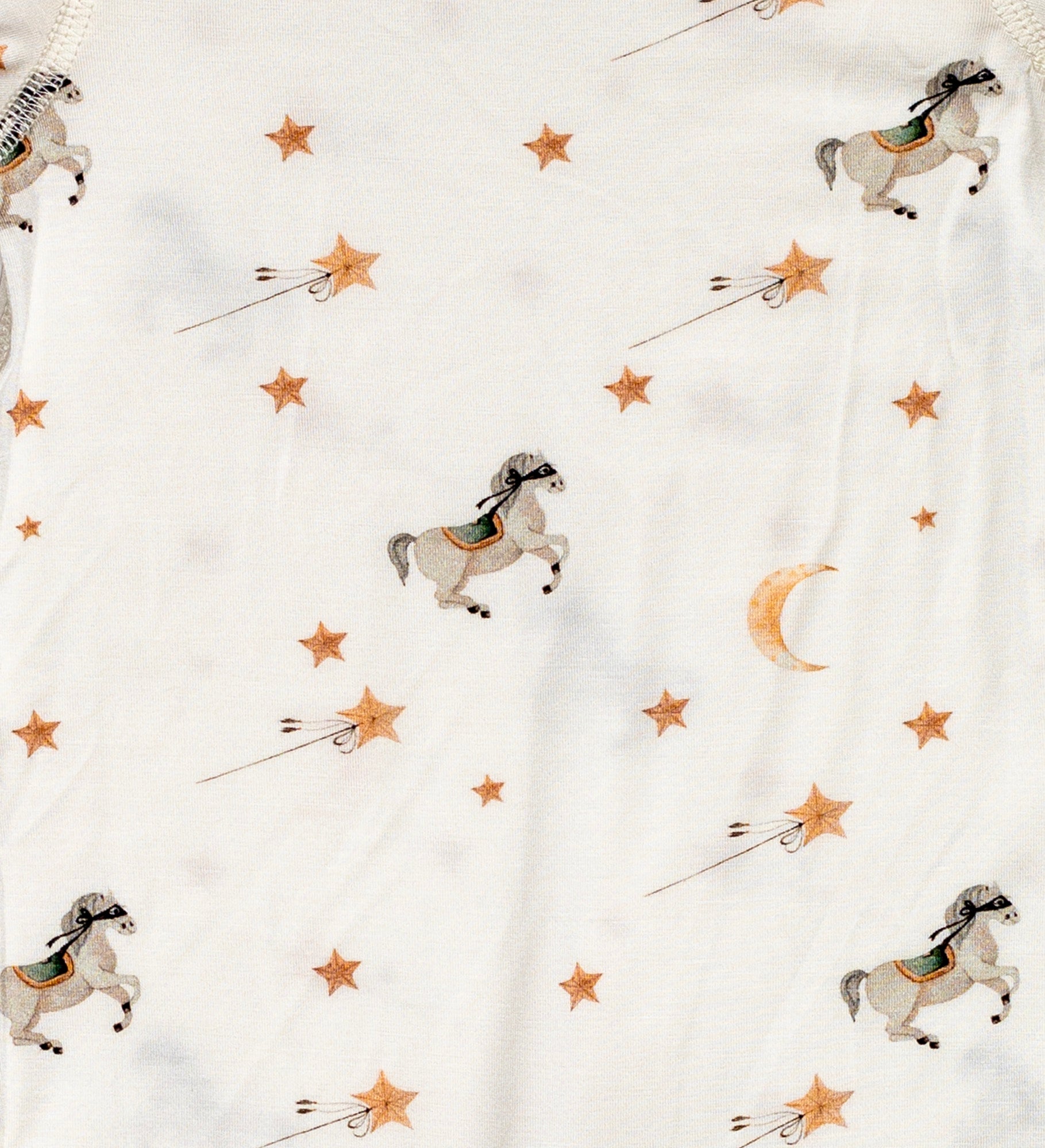 Ultra-soft bamboo long sleeve romper featuring a playful pony pattern with golden stars and moons.