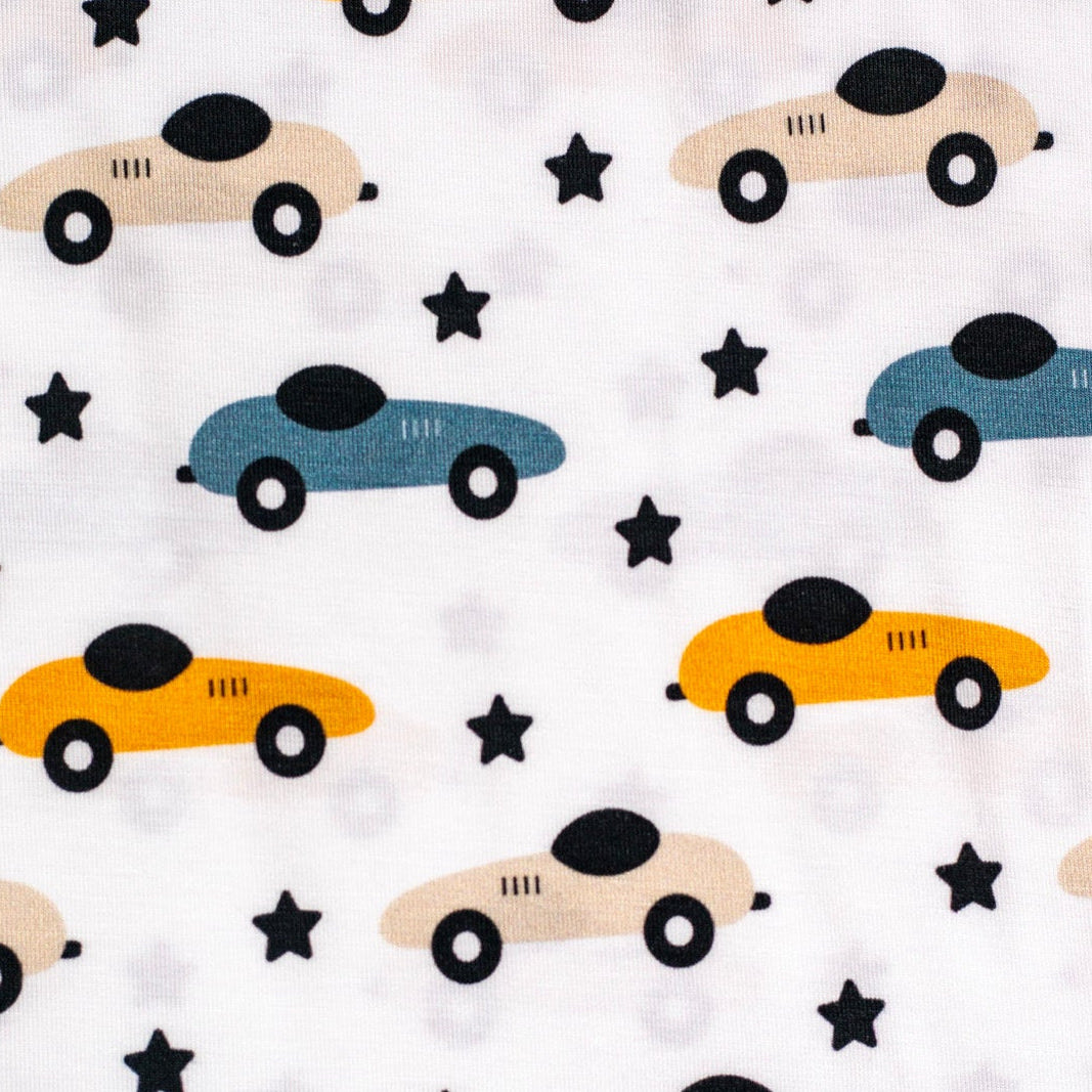 Playful bamboo pajama set with colorful race cars and twinkling stars, perfect for little speedsters.