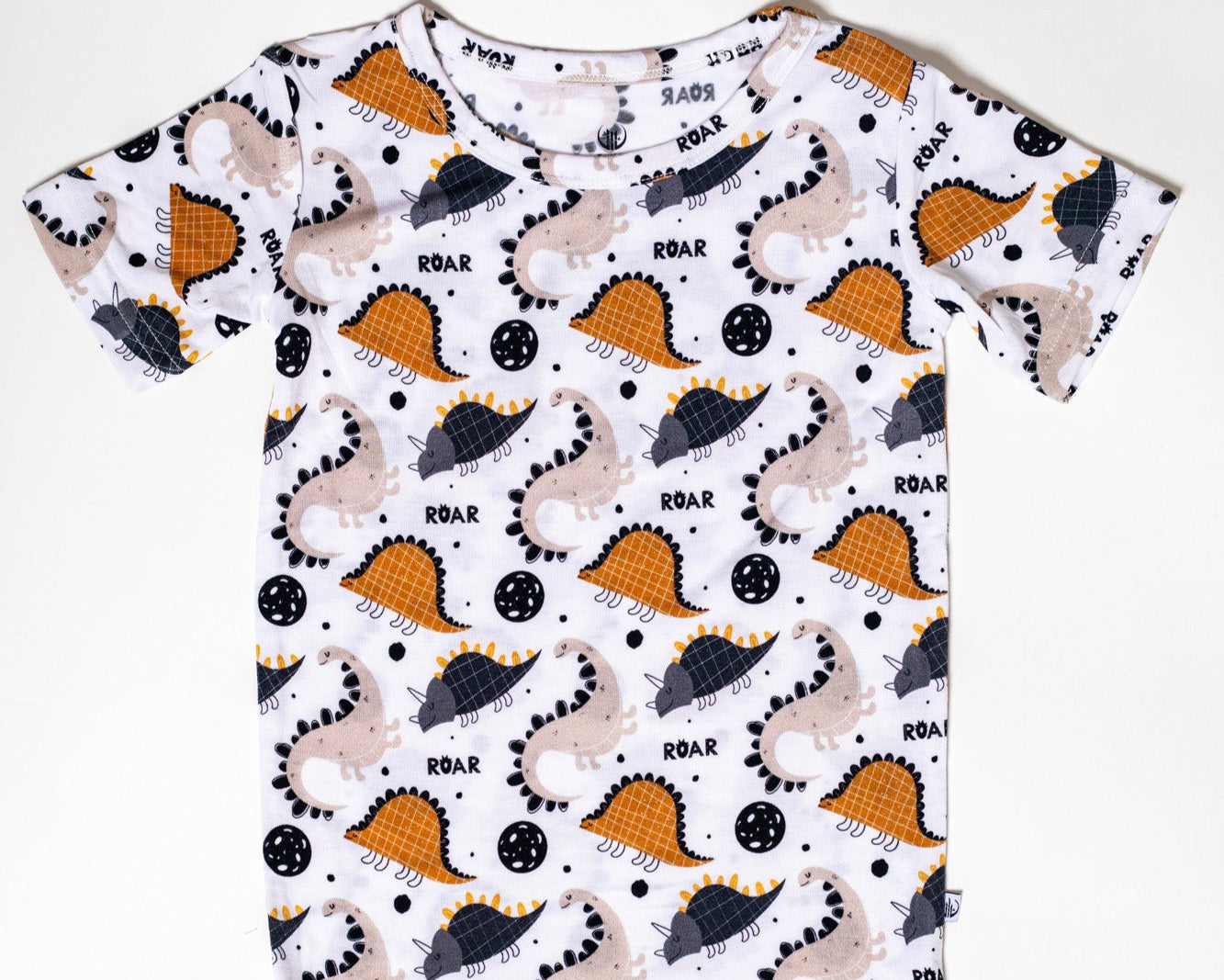 Eco-friendly and moisture-wicking bamboo pajama set with a roaring dinosaur design.