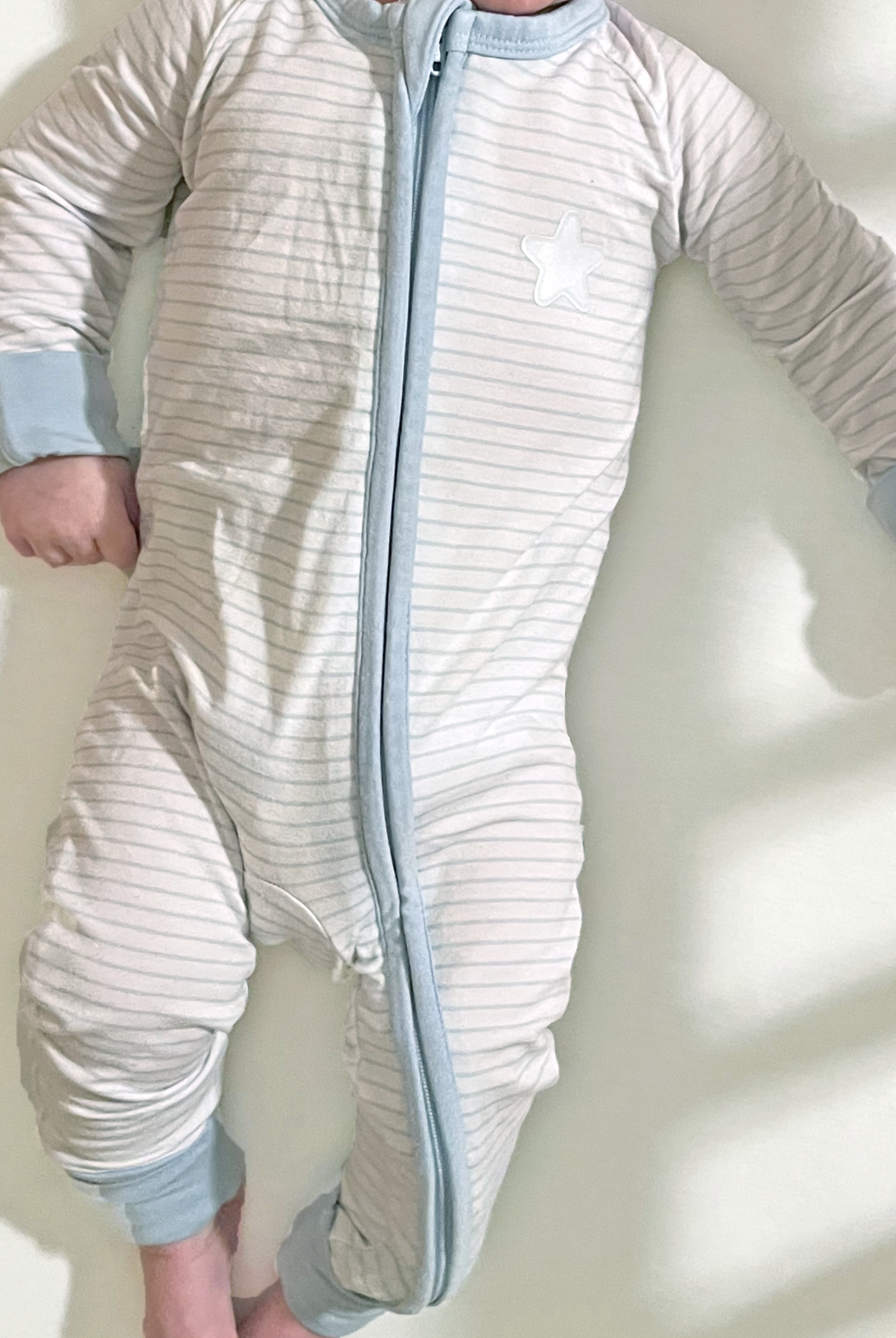 Super soft snuggles in a classic blue and white strip with celestial details. Perfect neutral bamboo dual zip sleeper with fold-over cuffs that grows with your baby.