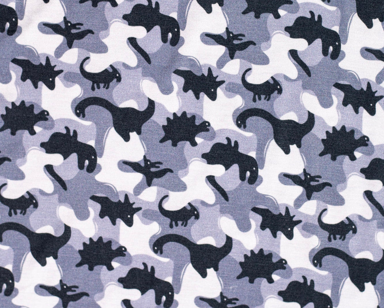 Earthly Threads kids' bamboo pajamas featuring a fun camo dinosaur print in gray, black, and white.