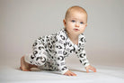 Sweet Dreams bamboo zip romper with a celestial pattern of stars, moons, and soft "Sweet Dreams" lettering for a cozy night’s sleep.