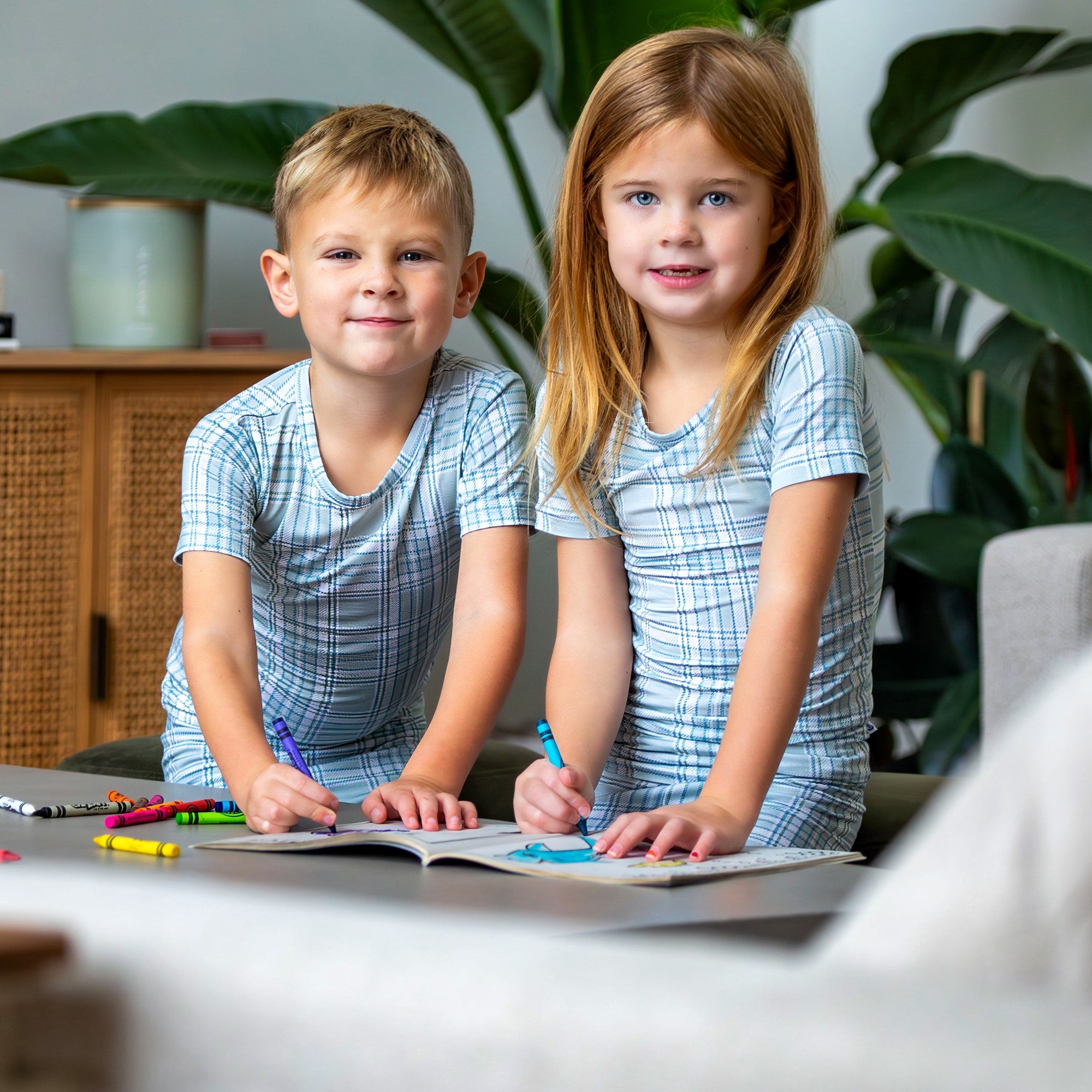 Earthly Threads buffalo plaid bamboo kids pajamas in neutral blue and white, available in short or long sleeves.