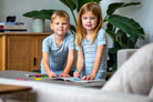 Earthly Threads buffalo plaid bamboo kids pajamas in neutral blue and white, available in short or long sleeves.