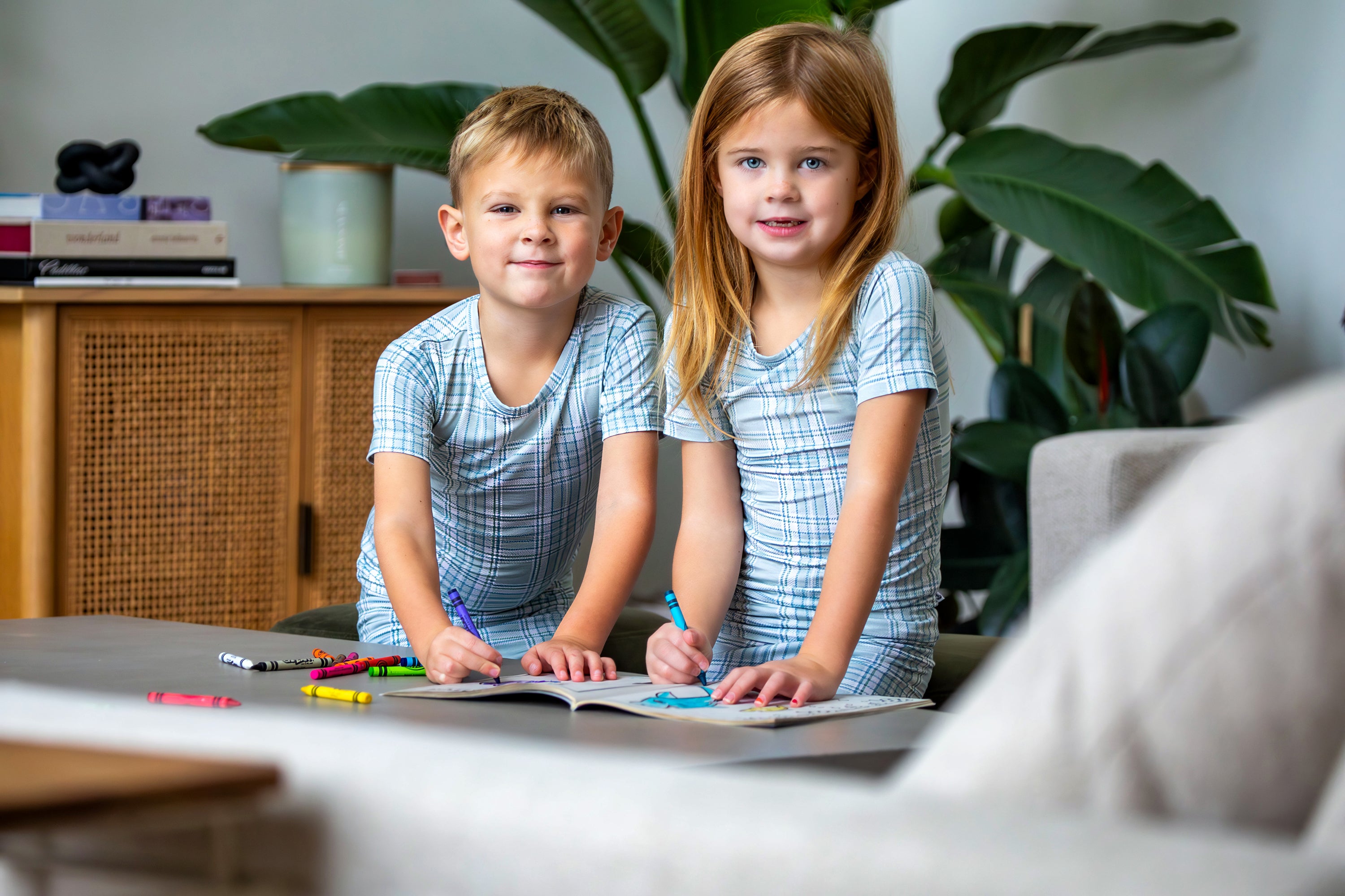 Earthly Threads buffalo plaid bamboo kids pajamas in neutral blue and white, available in short or long sleeves.