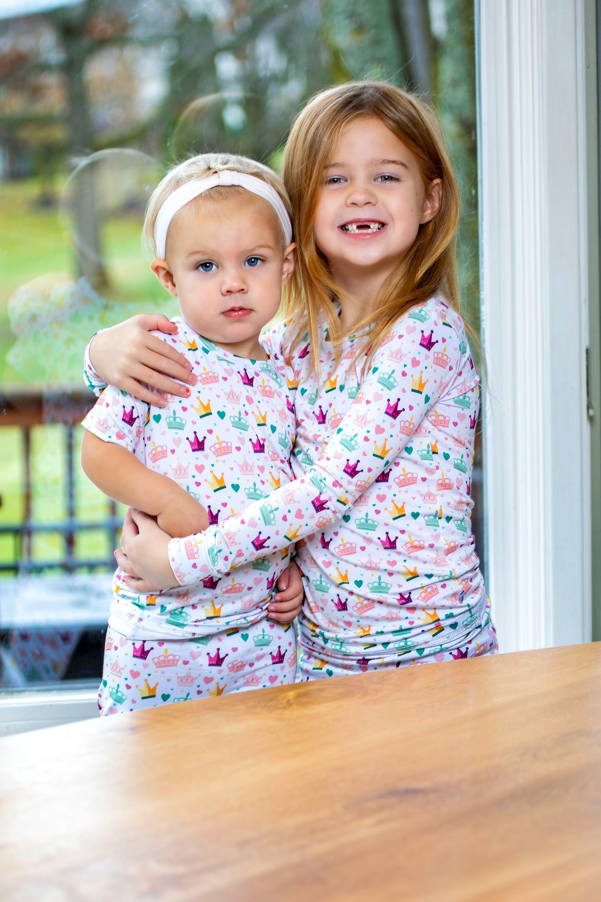 Pink and gold hearts and crowns kids’ pajama set made from Earthly Threads' antibacterial bamboo fabric.