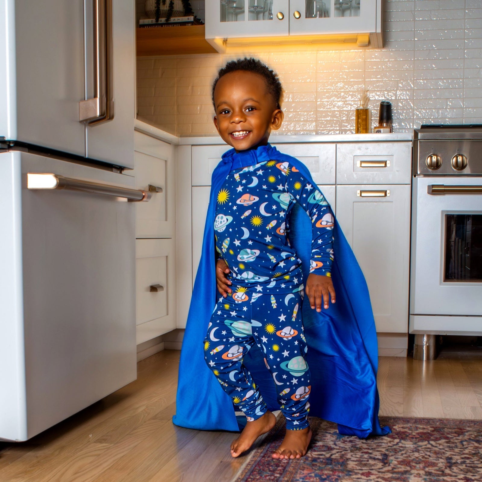 Galaxy-inspired kids' pajamas with a playful planets and spaceships print, designed for cozy, breathable sleep in a buttery-soft, hypoallergenic bamboo blend.