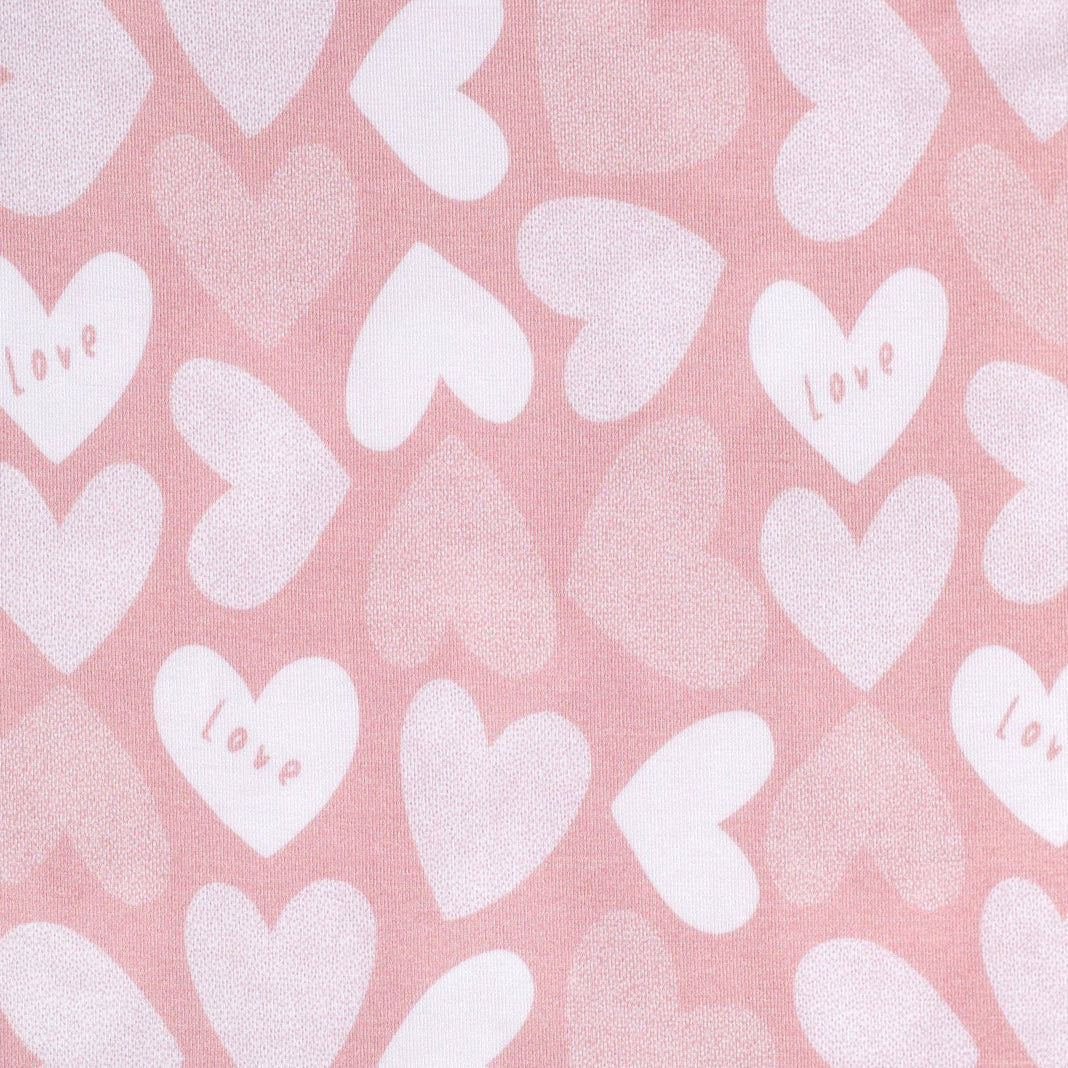 Ultra-soft bamboo kids’ pajamas featuring a sweet pattern of hearts and love lettering.