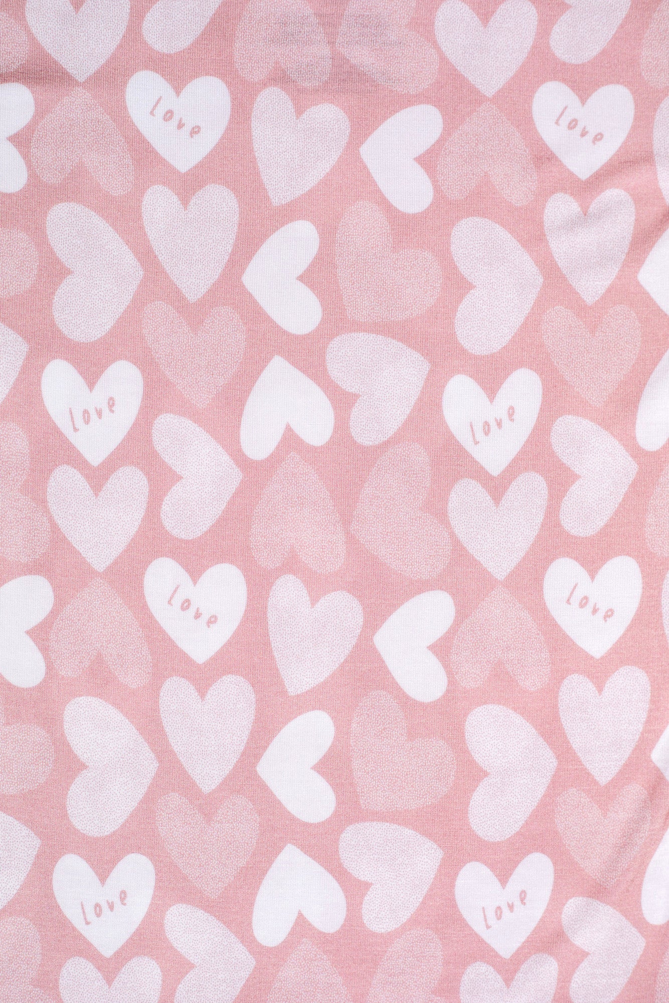 Ultra-soft bamboo kids’ pajamas featuring a sweet pattern of hearts and love lettering.