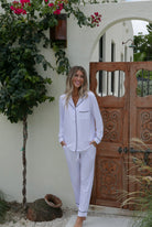 Timeless Unwind Pajama Set featuring a button-down long sleeve top with contrast piping and tapered pants with pockets.
