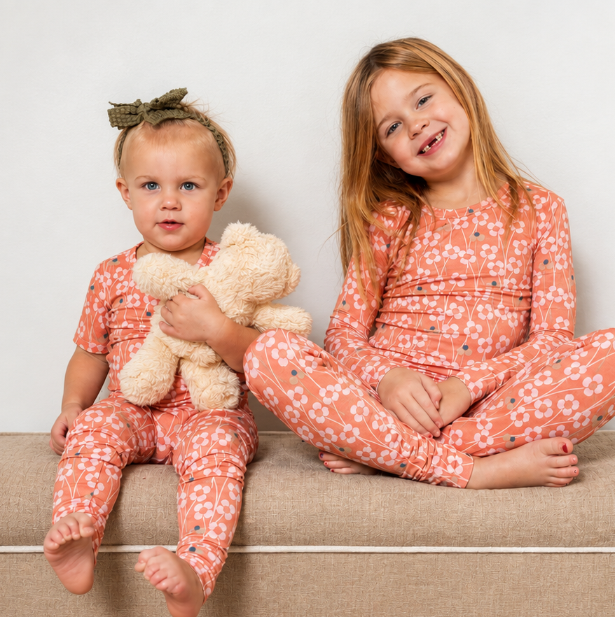 Bright and whimsical orange blossom bamboo pajama set with soft, breathable fabric for dreamy comfort. Available in short or long sleeves with pants.