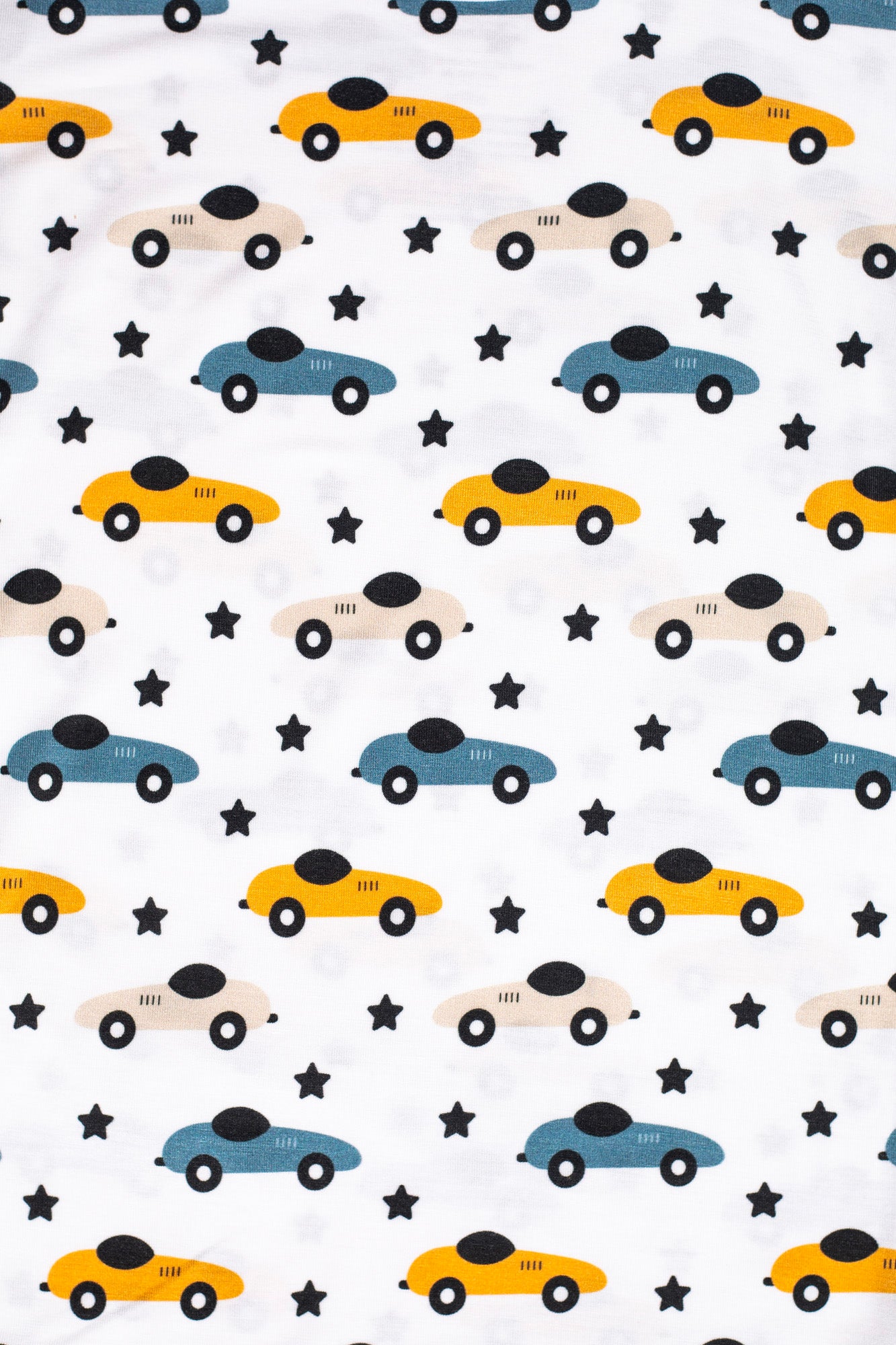Eco-friendly bamboo pajama set with a fun race car and star pattern, designed for bedtime adventures.