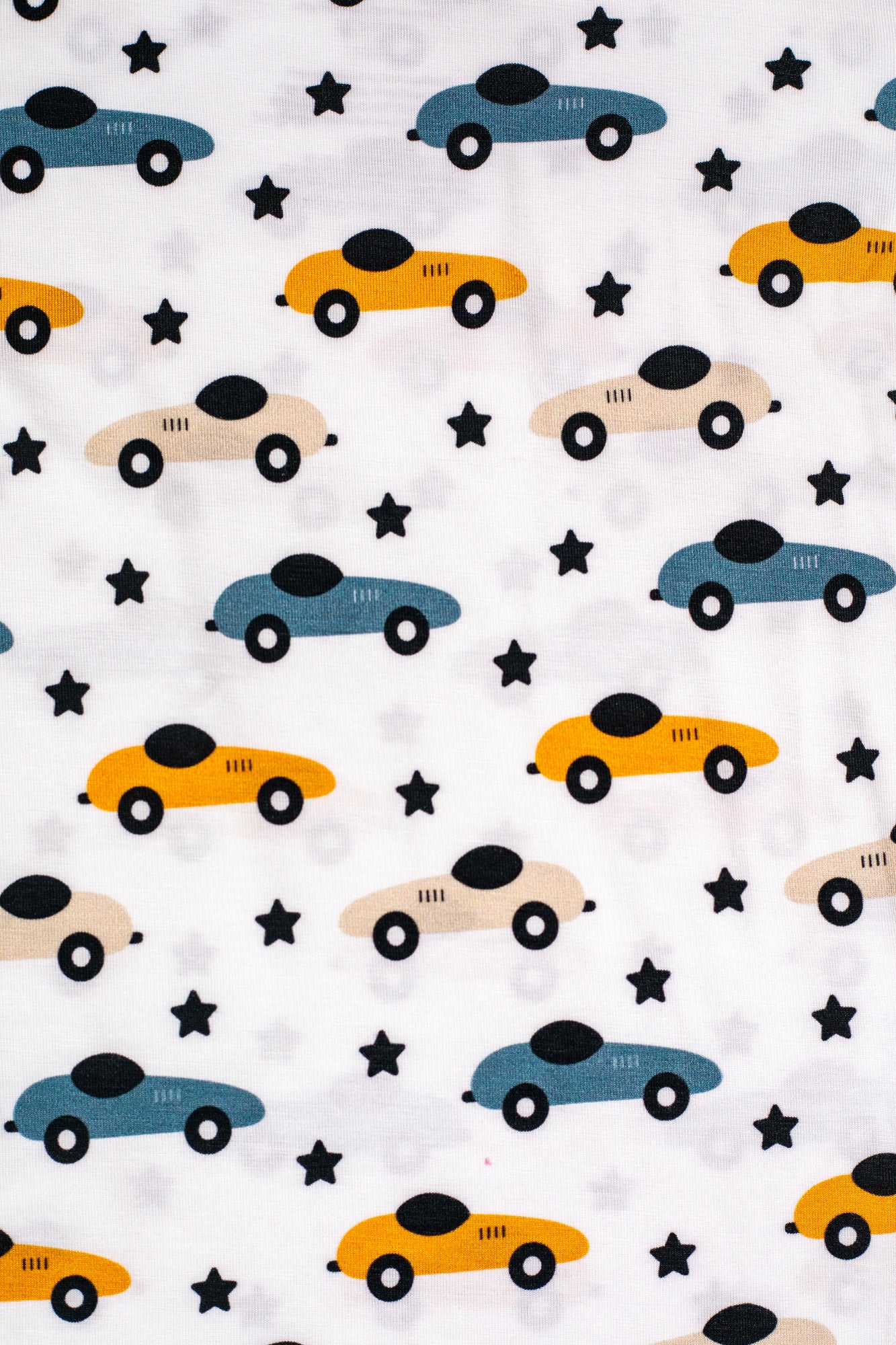 Playful bamboo pajama set with colorful race cars and twinkling stars, perfect for little speedsters.