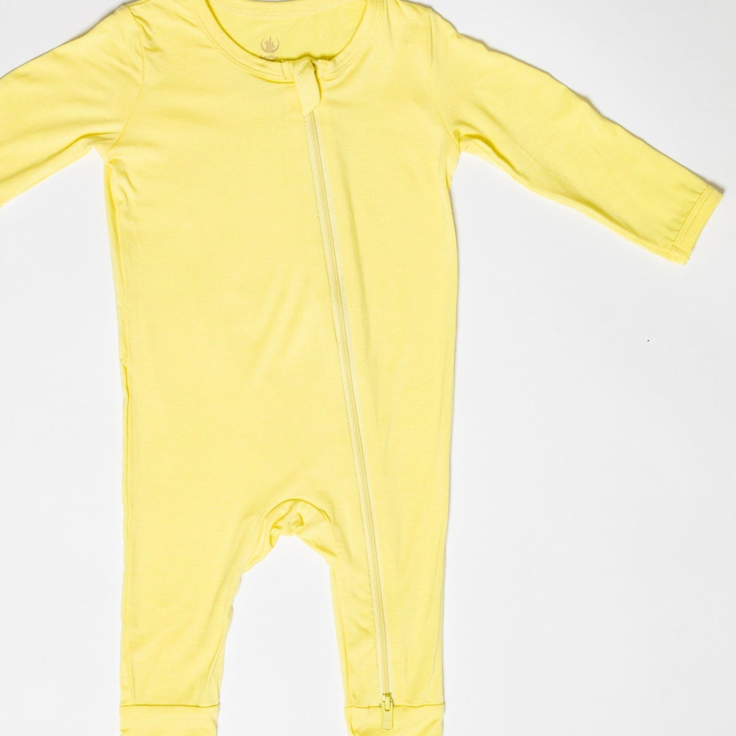 Bamboo long sleeve baby romper in yellow, offering natural antibacterial and hypoallergenic benefits for sensitive skin.